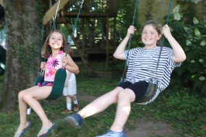 Girls enjoy the swings at the end of school party held at Ashalwn estate, hosted by Joe Lara and Gwen Shamblin Lara.